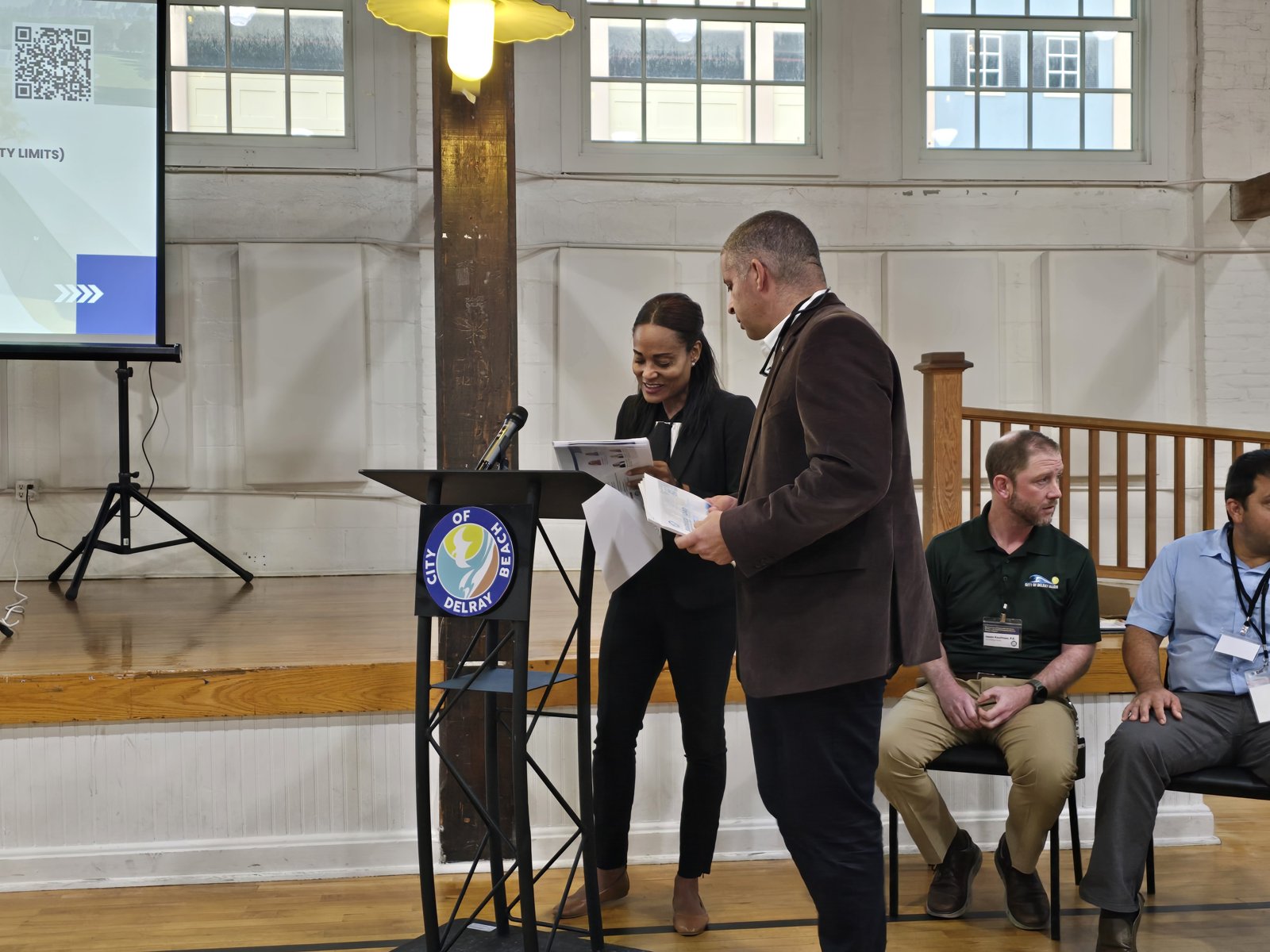 Speakers address attendees at the public information meeting.